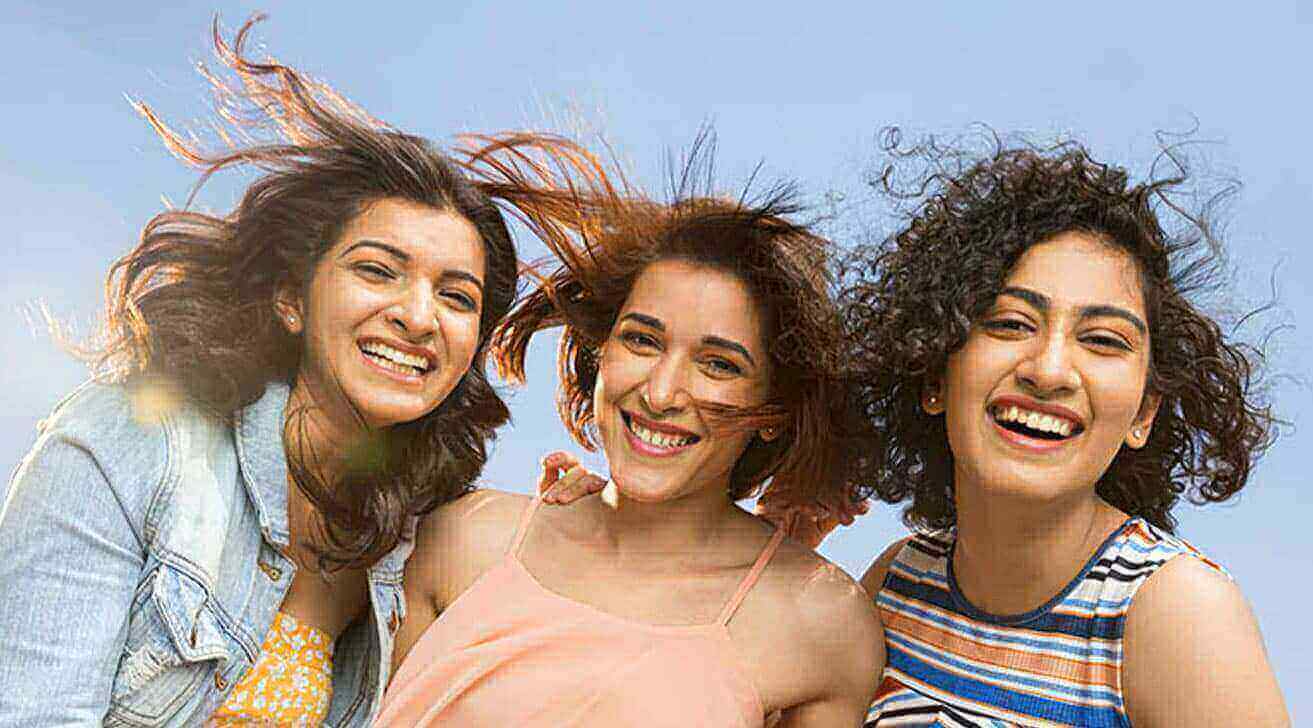 Three women happy with their soft and shiny hair