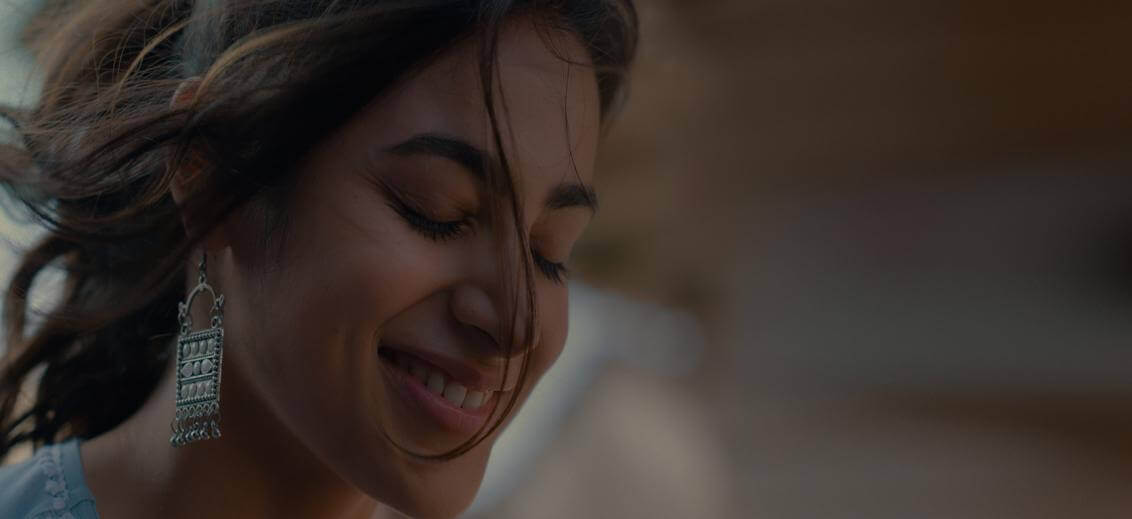 A happy woman with her soft hair fair flying in the wind